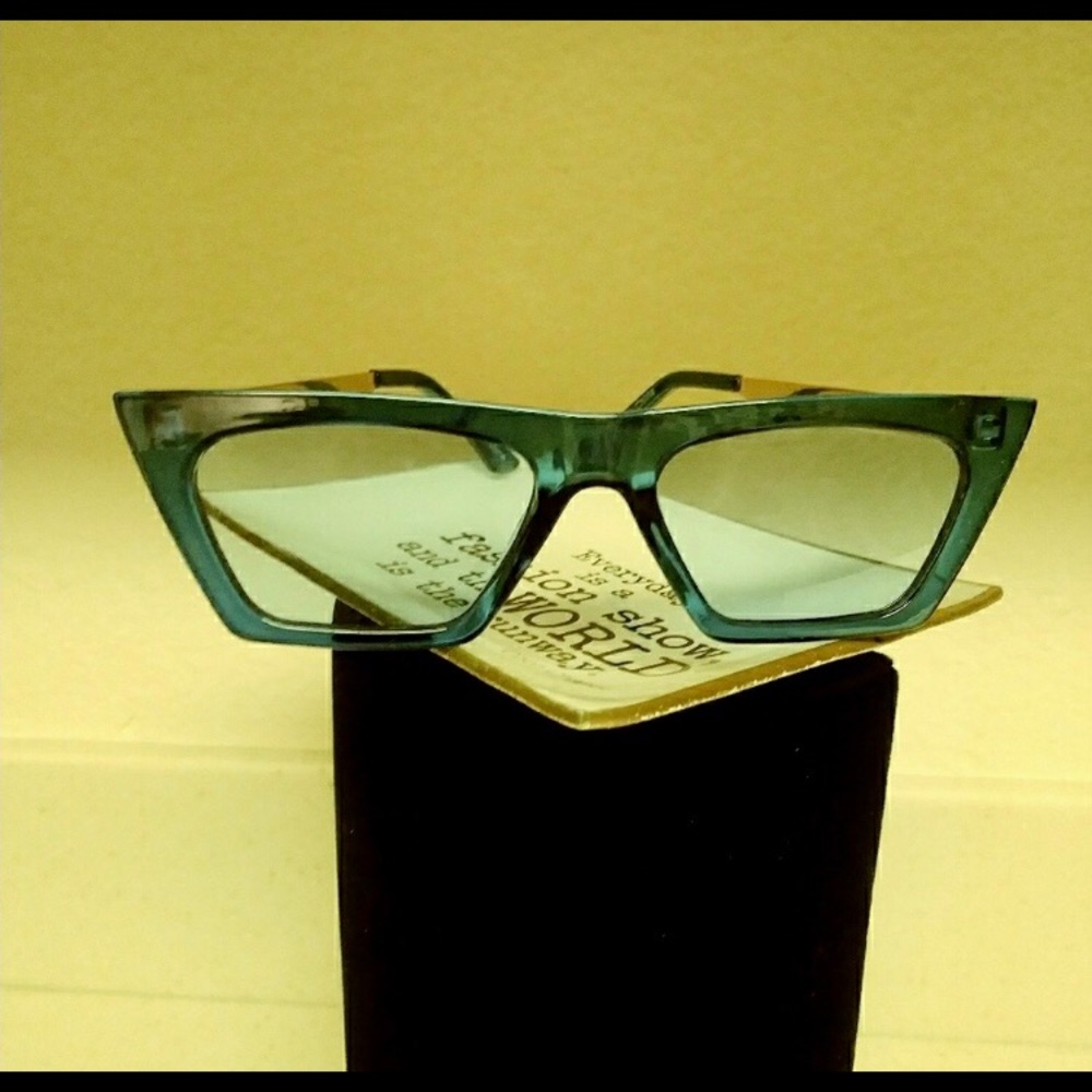 Structured edgy aqua blue framed glasses with blue lenses.